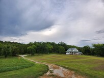 The house has a huge field between it and the river bank