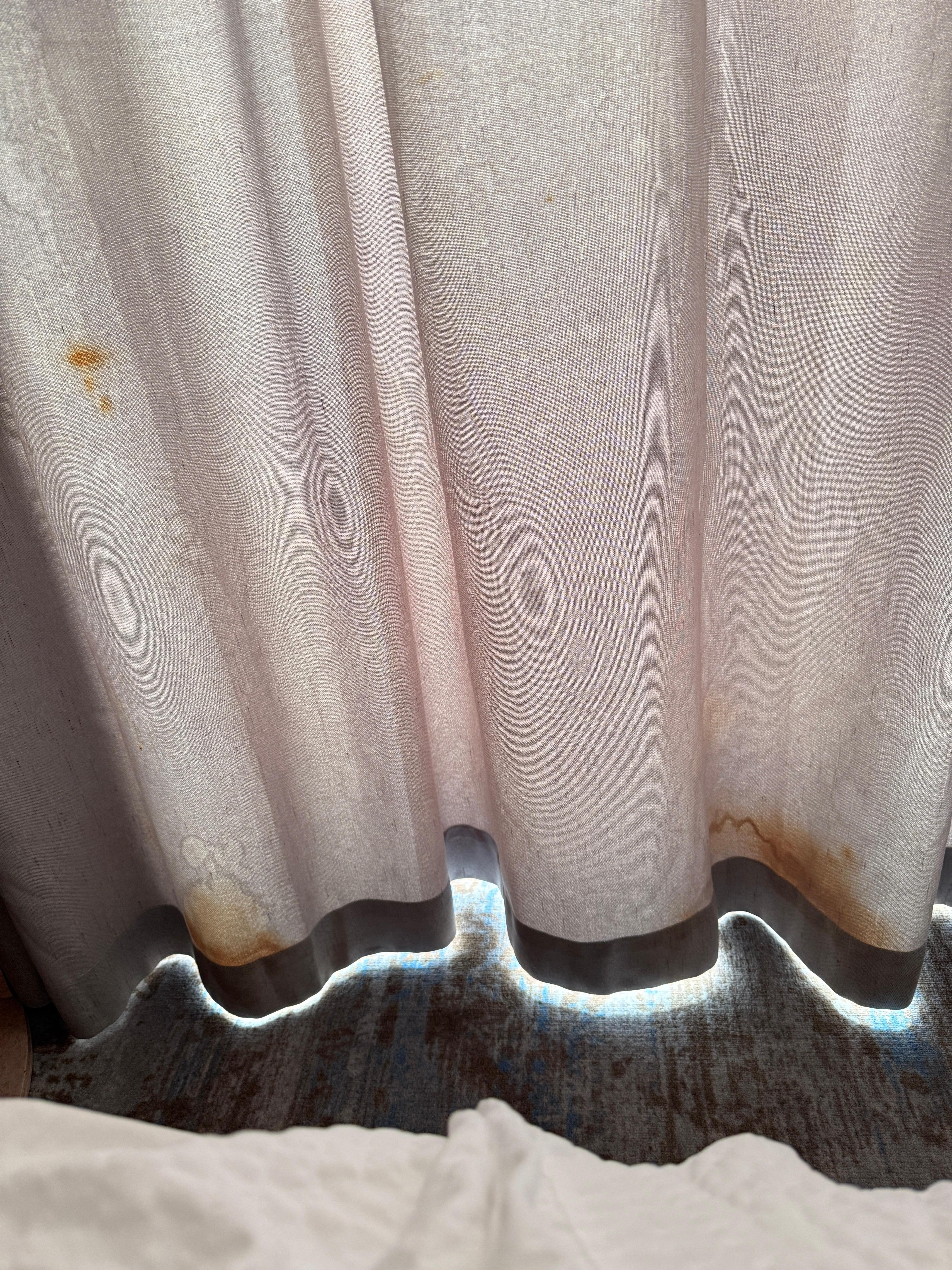Terrible stains on the curtains that look moldy.