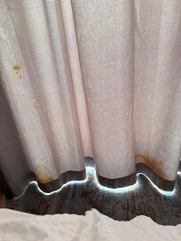 Terrible stains on the curtains that look moldy.