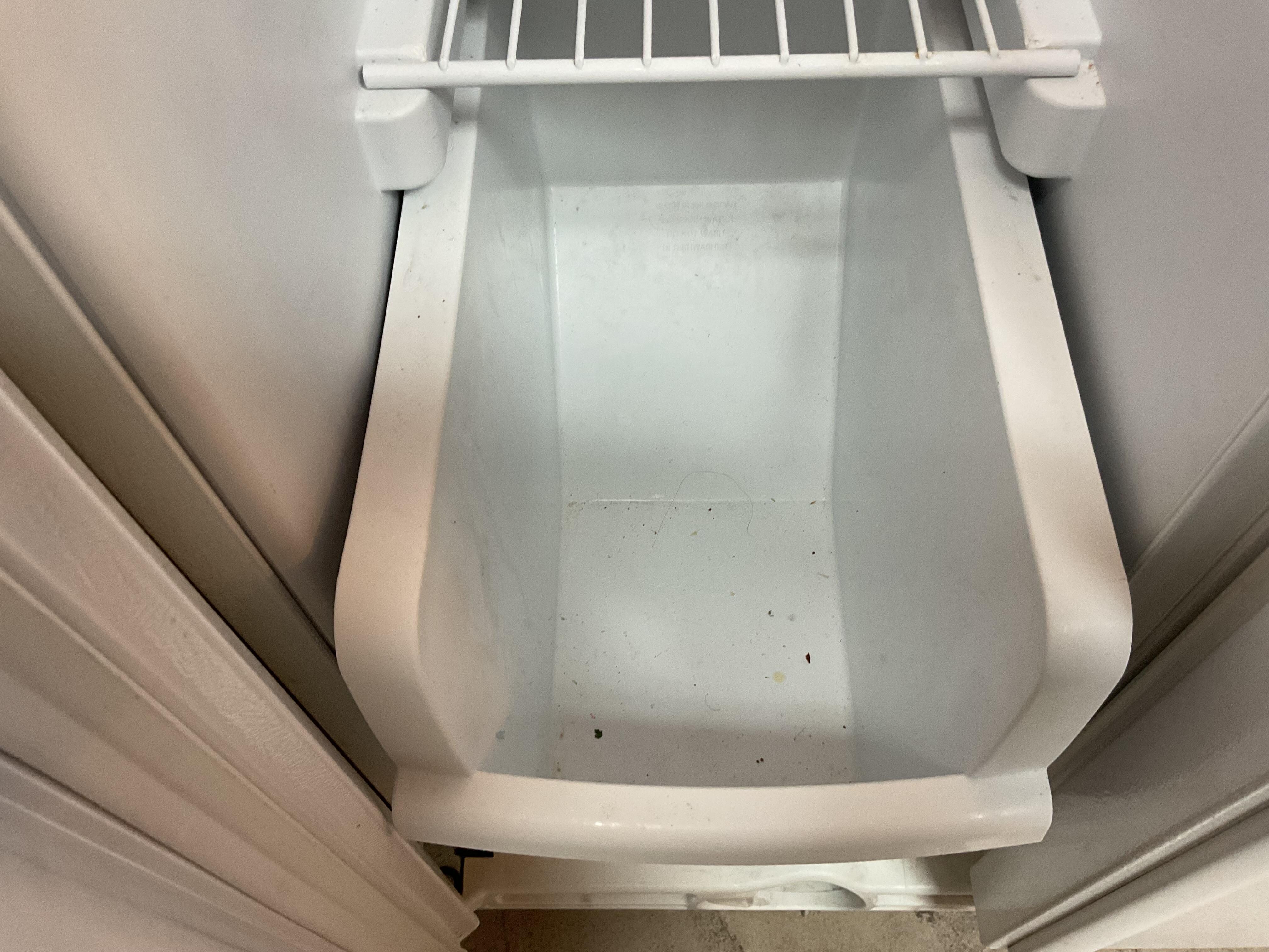 Long black hair in refrigerator with old food crumbs in all the drawers 