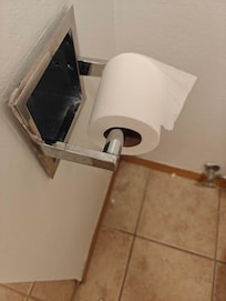 Our bathroom. Paint splatter everywhere. Holes in doors and walls. TP dispenser wasn't mounted.