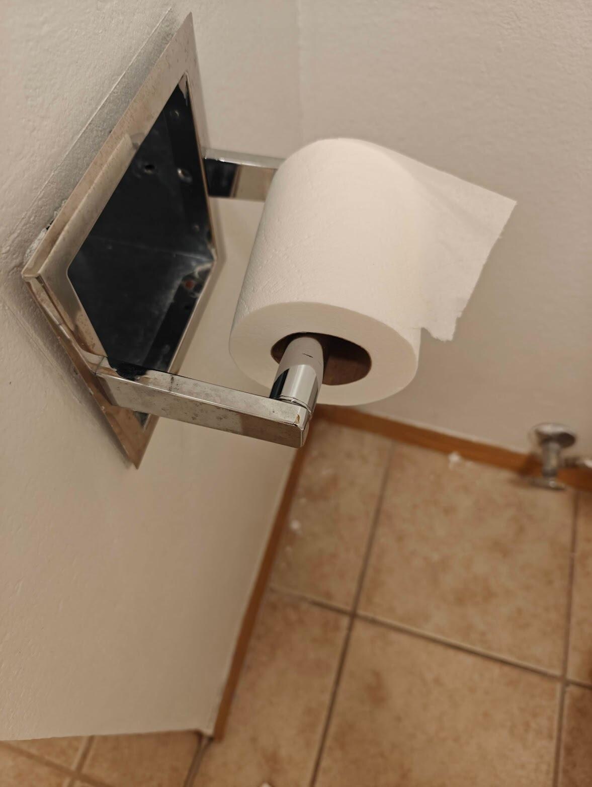 Our bathroom. Paint splatter everywhere. Holes in doors and walls. TP dispenser wasn't mounted.