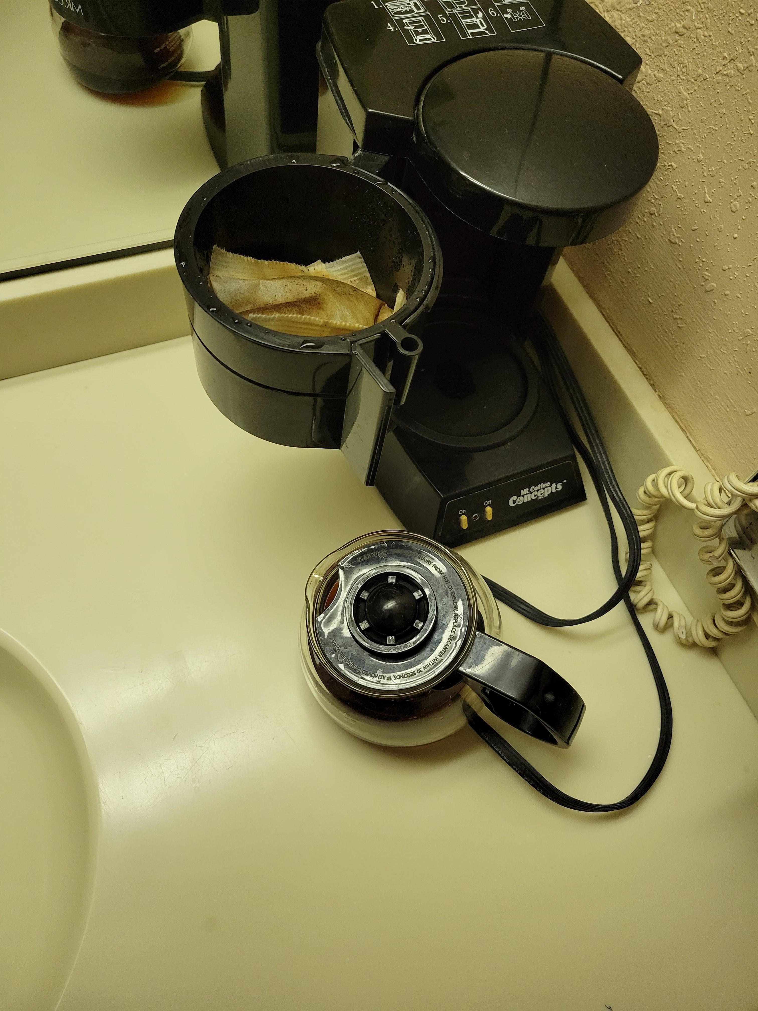 Coffee pot - old coffee grounds still in top and coffee pot 1/2 full of old coffee when we checked into the room