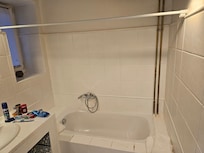 No shower curtain, and your kneeling down shower head.