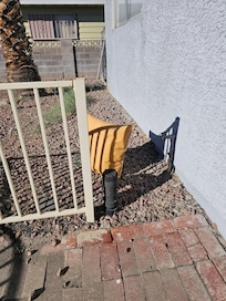 A random pillow in the flowerbed.