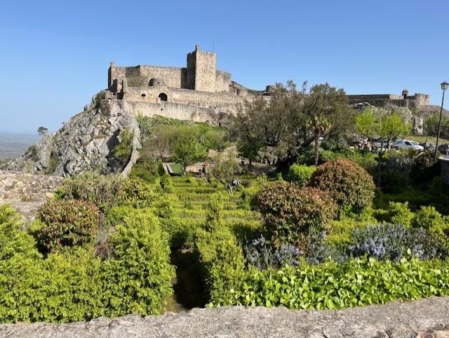 Marvão Castle, preceded by a lovely garden with rosemary and hydrangeas.
