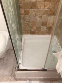 Half door panel gone missing. Other hanging loose. Shower base took ages to drain so your feet get a bath