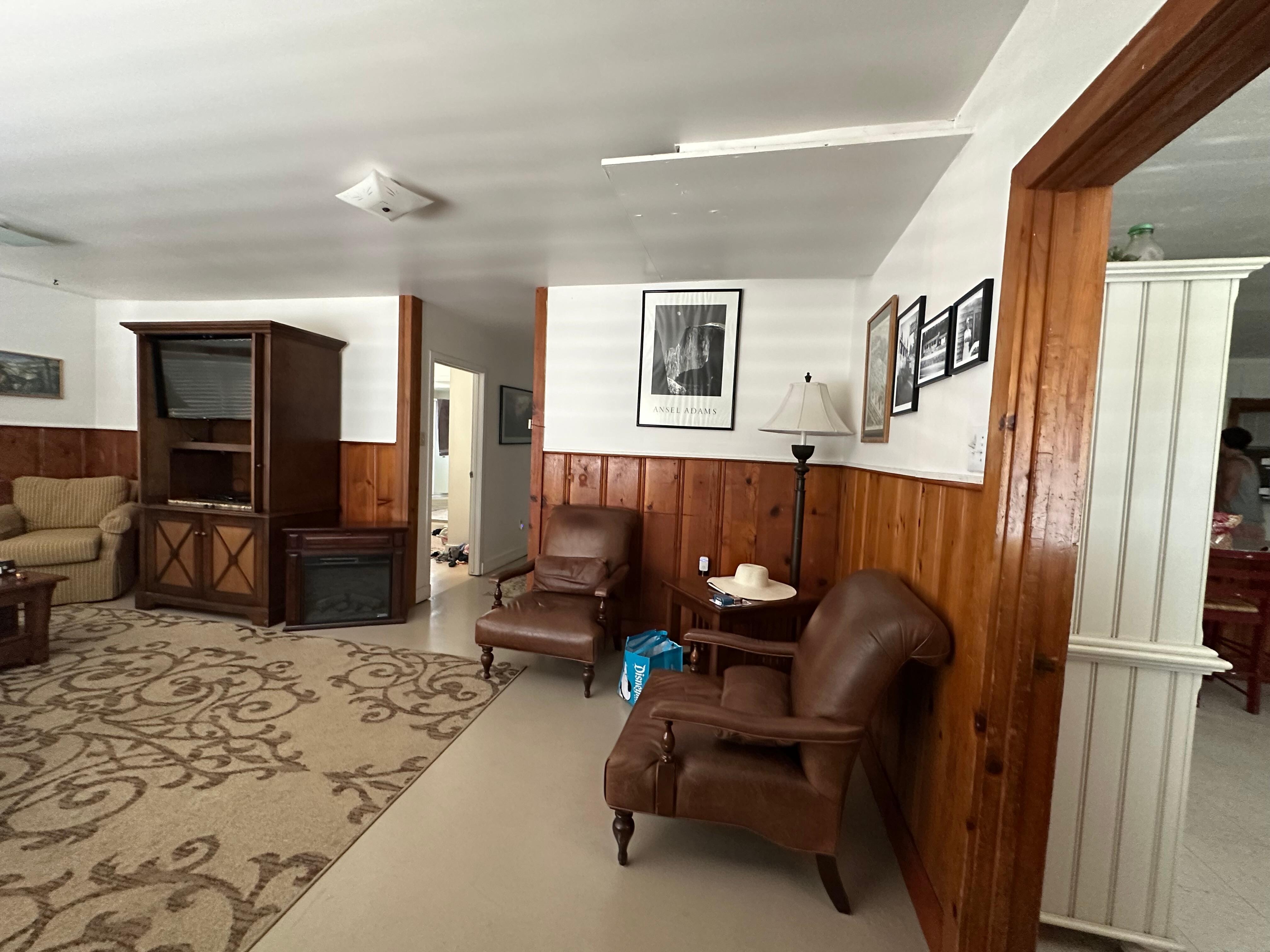Big living room (wraparound couch not pictured) with TV and board games.
