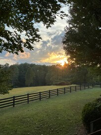 Field in front of cabin as sunsets.