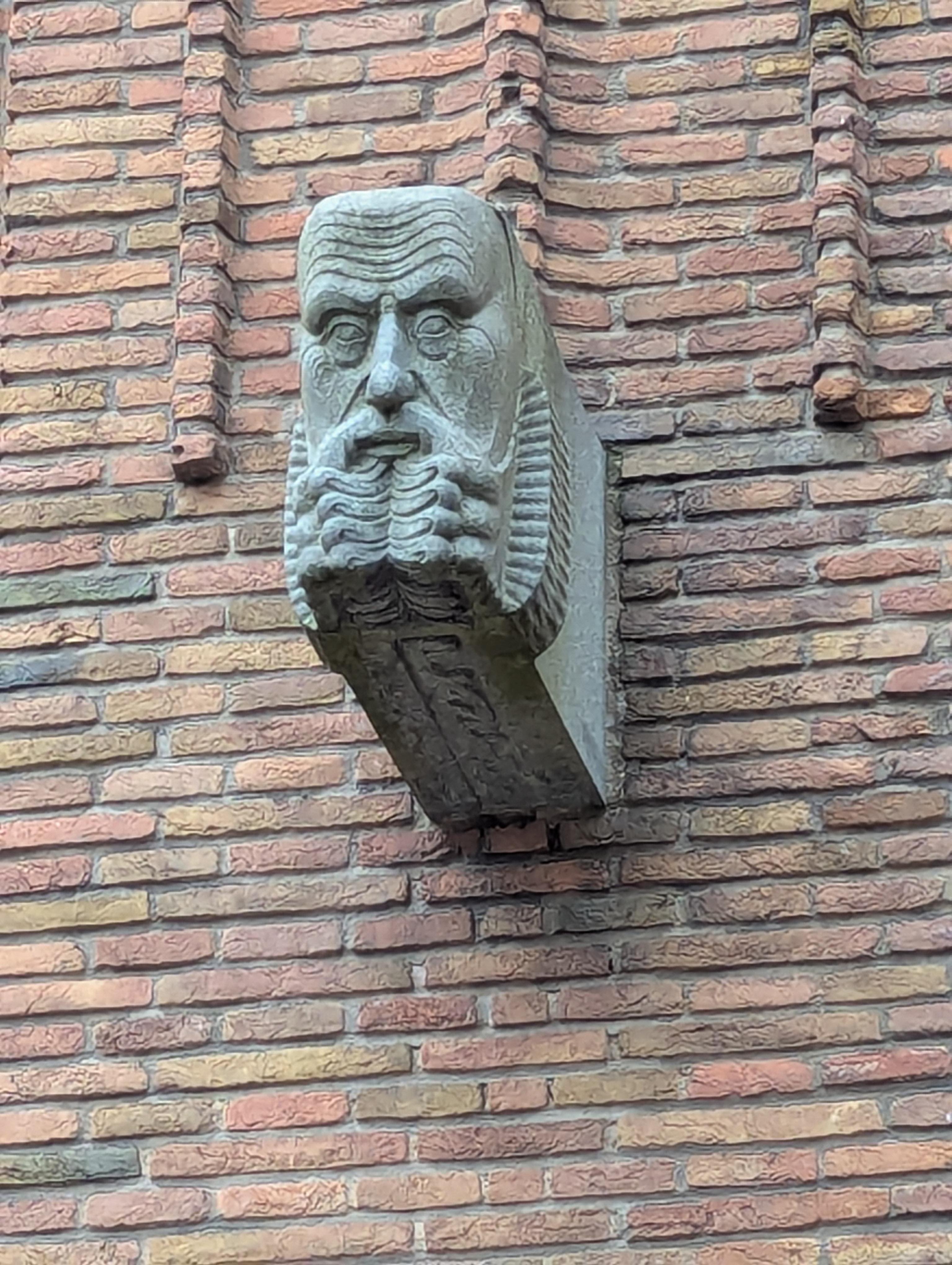 One of the many stone faces on the building.