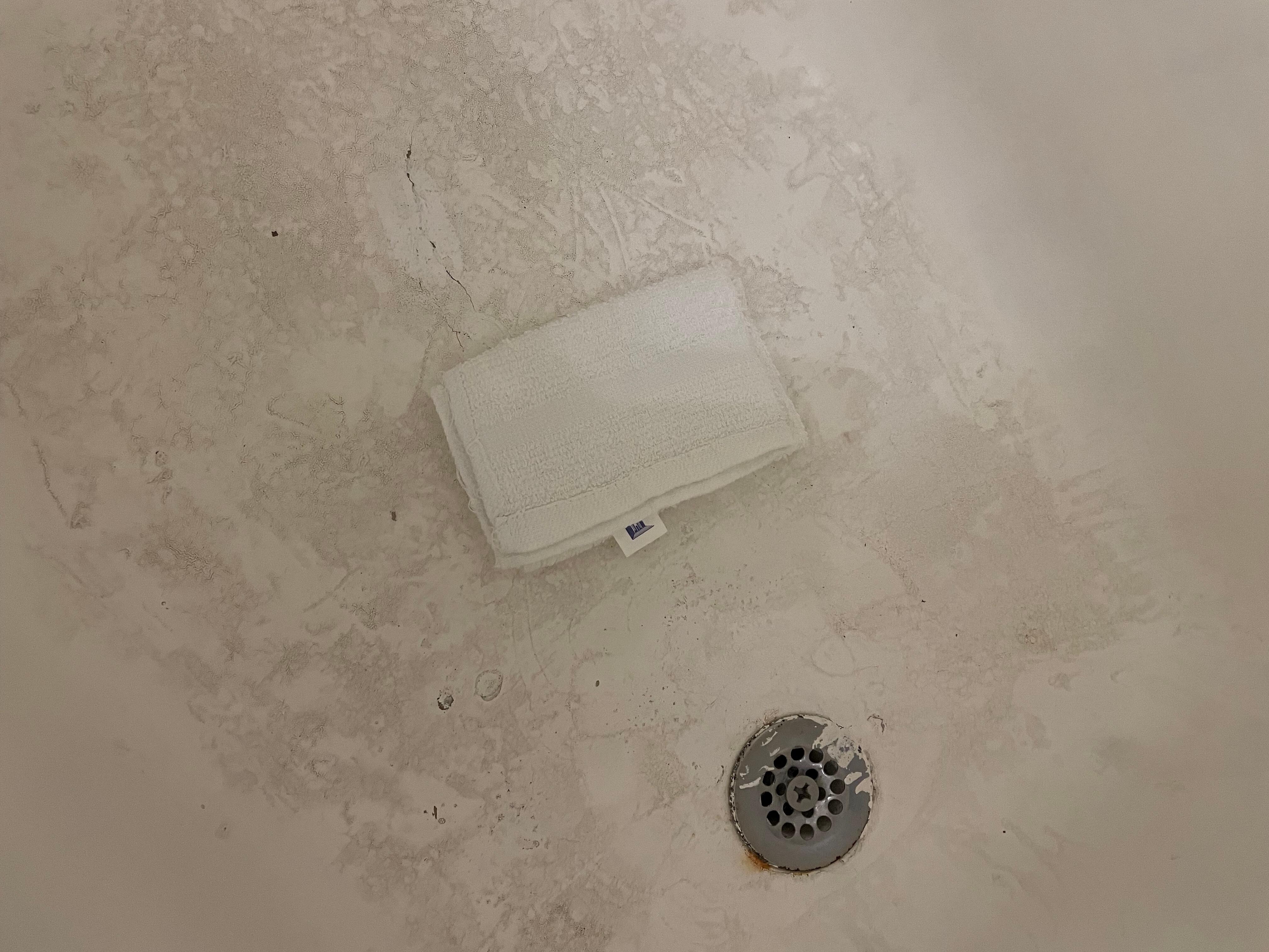 Filthy tub.  Washcloth for comparison