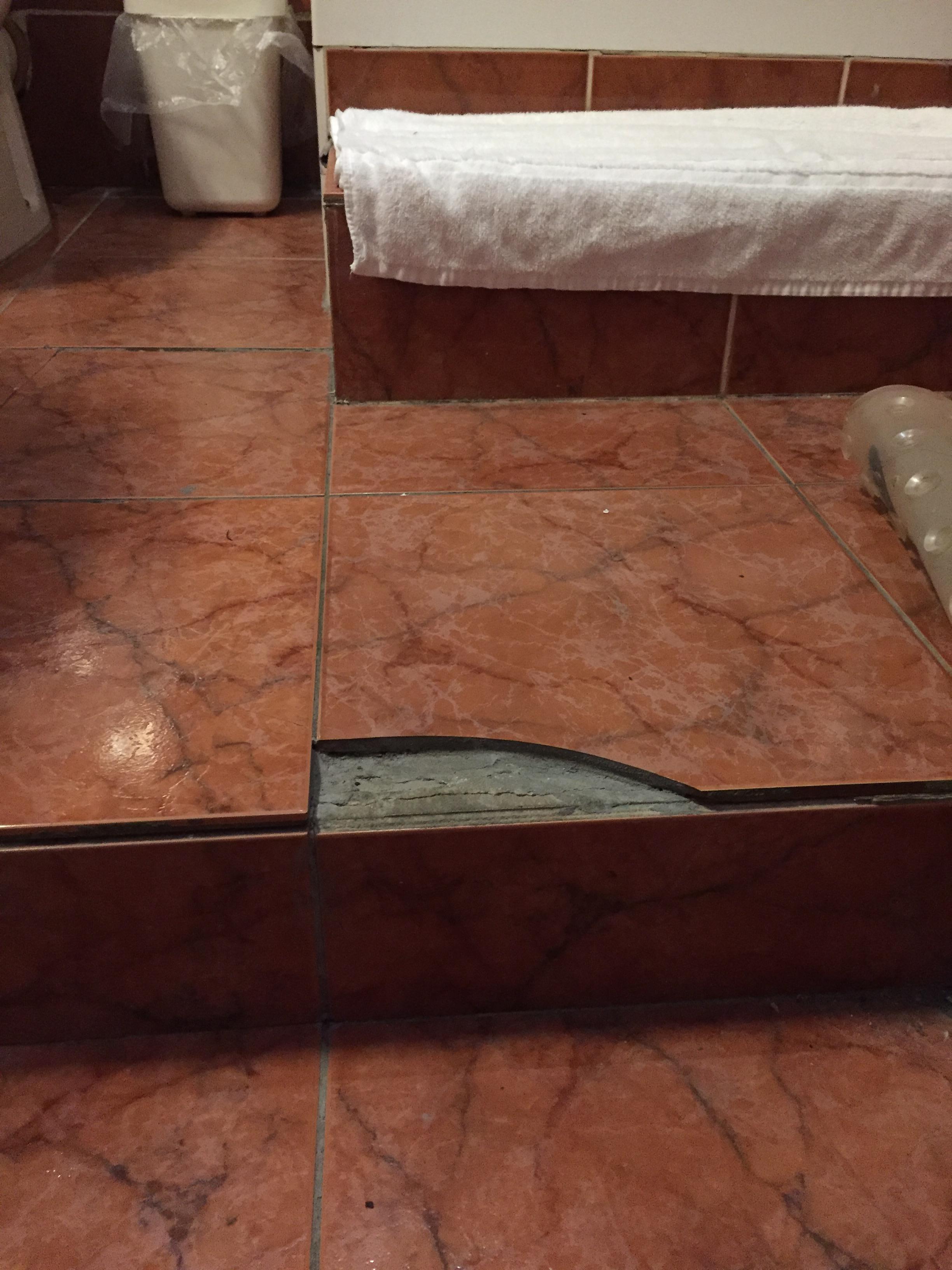 Tiled step in shower room needs serious attention 