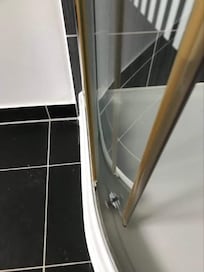 Shower screen door old and jamed.