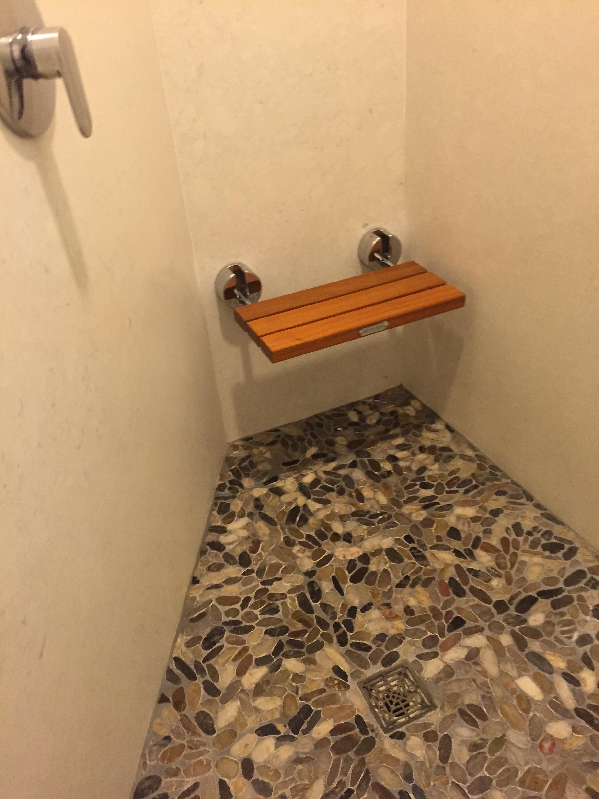 Pebble floor shower w teak bench