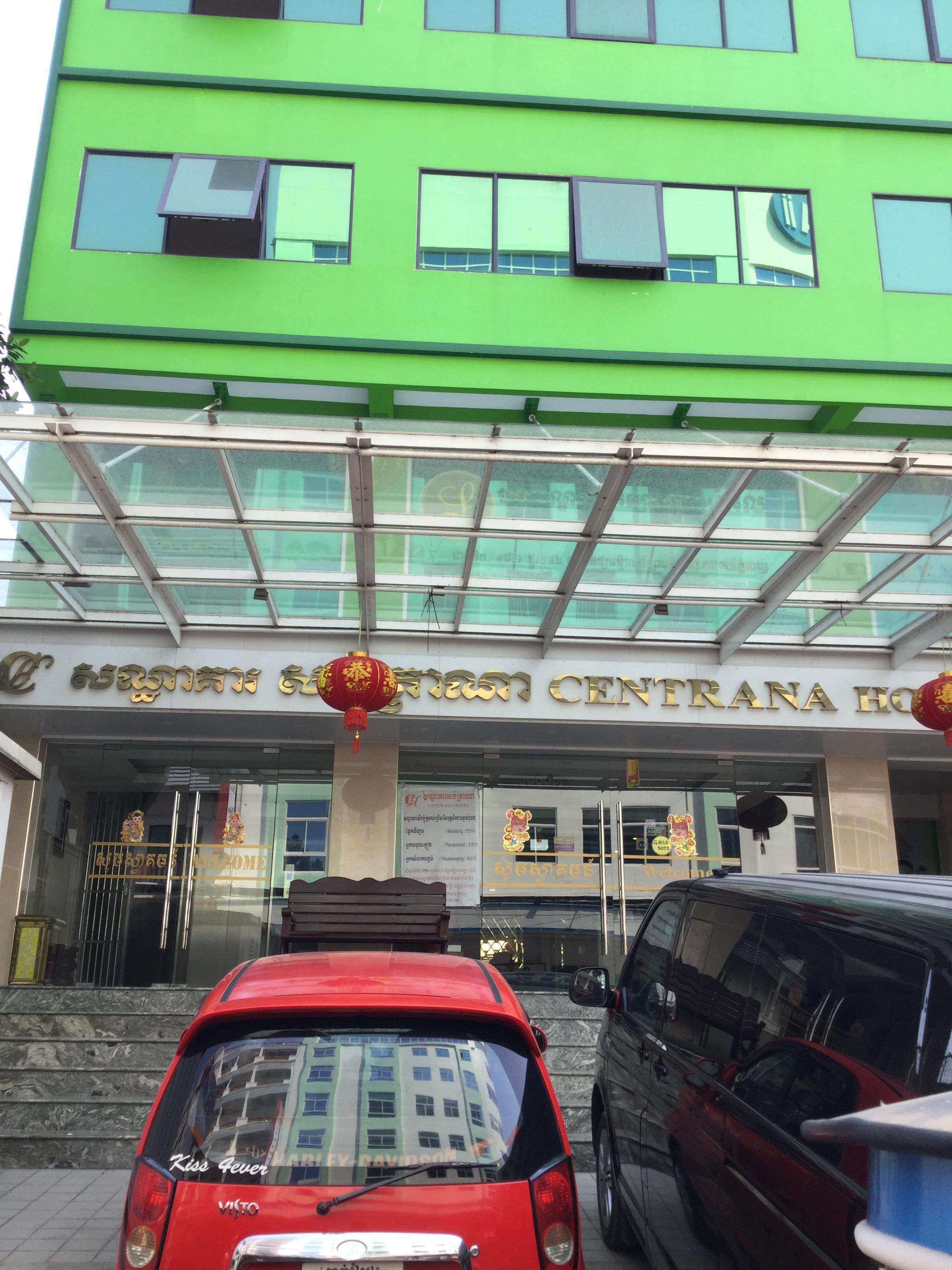 Green building with about 10 floors and a functional elevator.