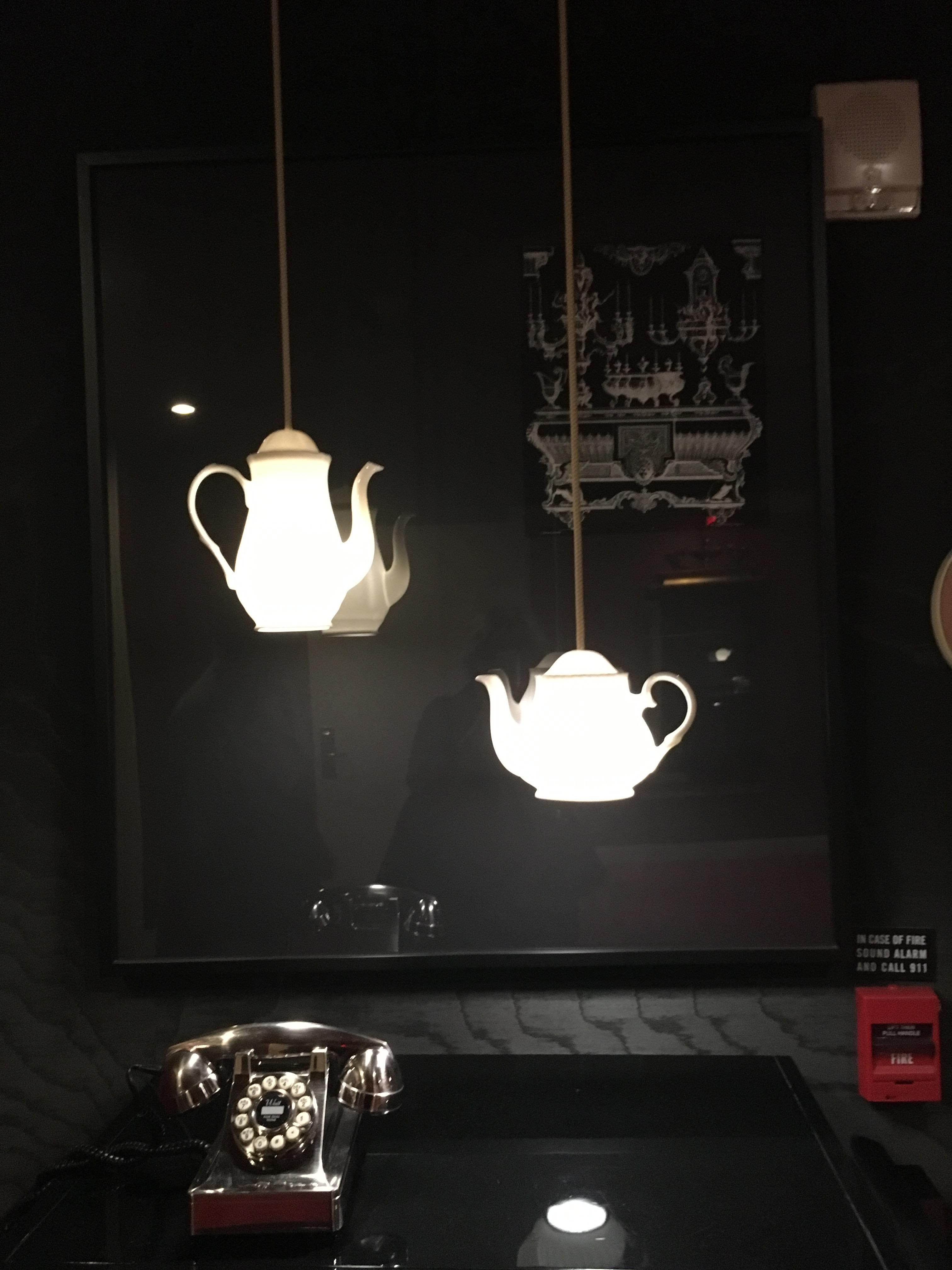 Teapot lights next to the elevator.