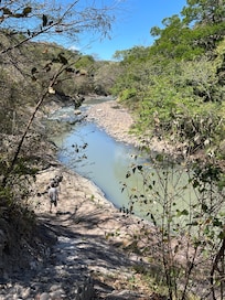The river below is accessible by stairs that lead to a lovely picnic area.