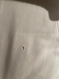 cigarette burn holes in the sheets