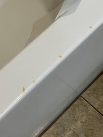 Cigarette burns on bathtub