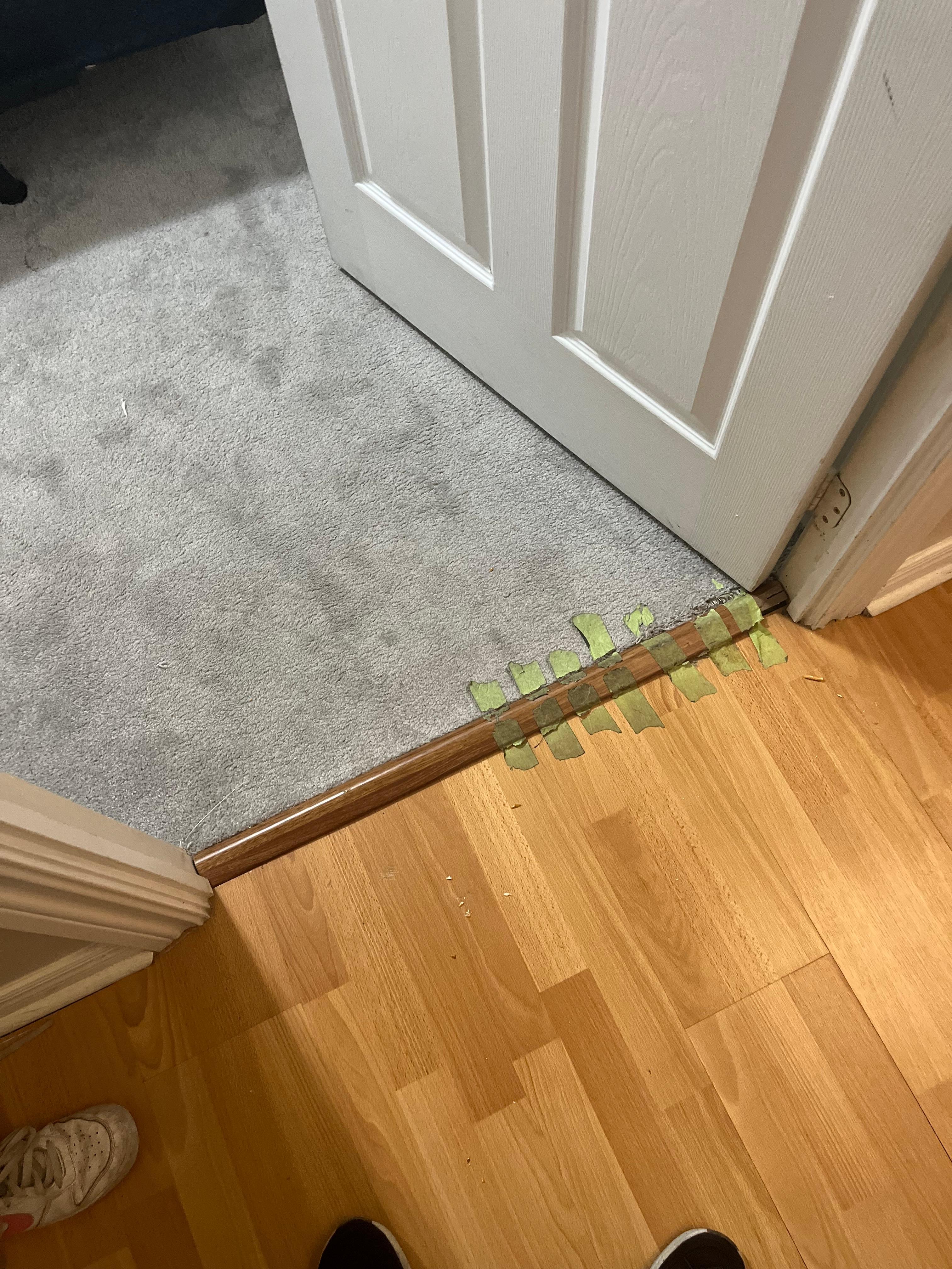 Tape on the floor to hold down the carpet