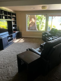 Beautiful movie area with hot tub outside.