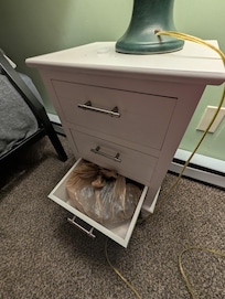 Here is the bedside table in the same room as the above captioned photo. What was left in that drawer, you ask? Oh, that's just a prior guest's used, poopy underwear.