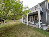 The patio is directly off of the living room and a private view of the river and woods.