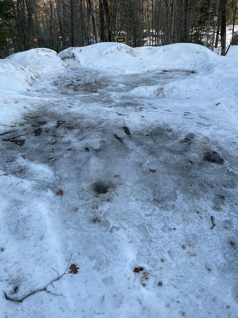 parking pad covered in ice and entry to hill at end