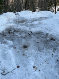 parking pad covered in ice and entry to hill at end