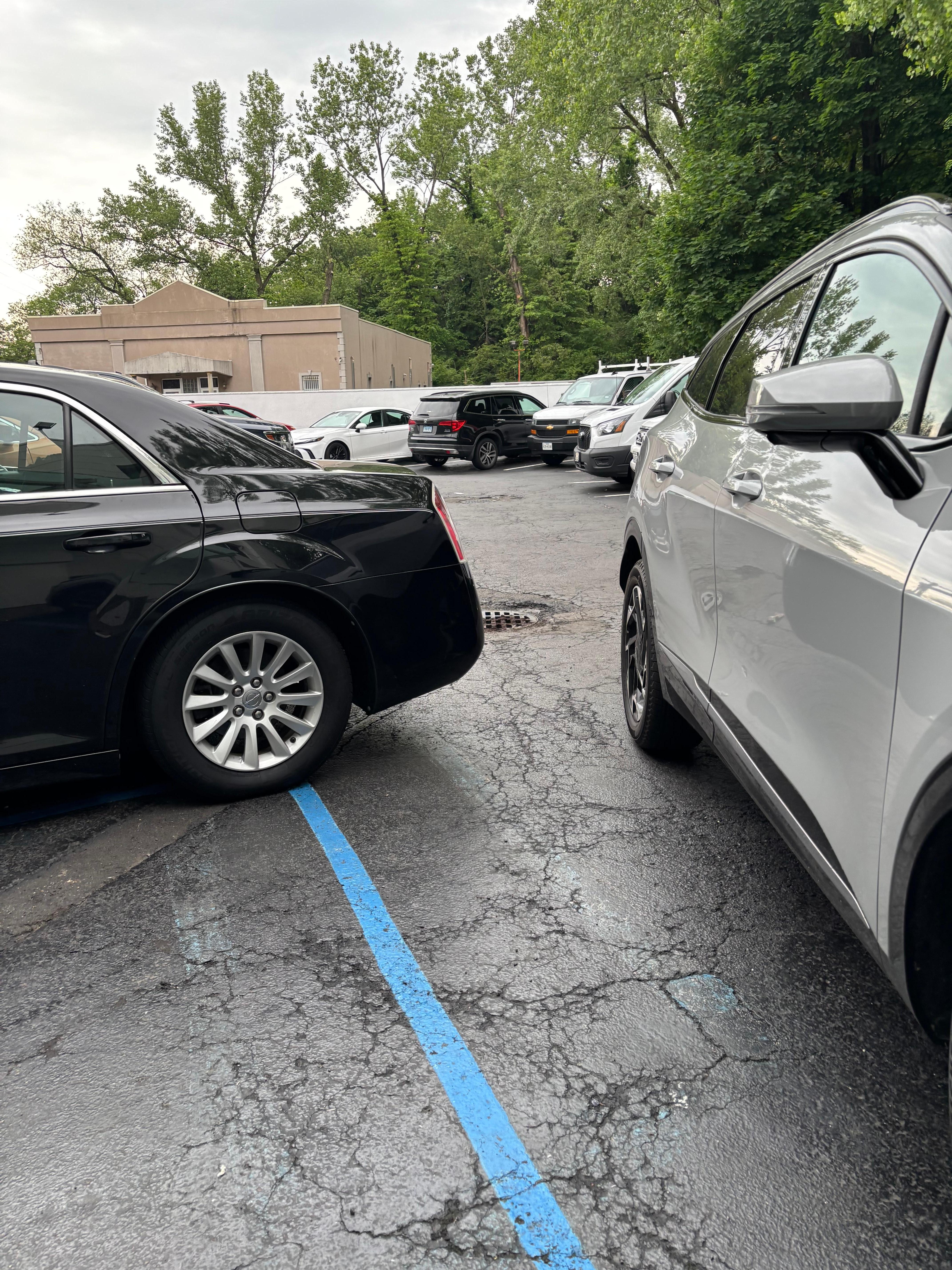 Black car parked in handicap. Silver was employee who yelled at me when she’d blocked in not only my car but 2 others.