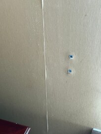 Peeling wallpaper and holes in wall