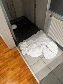 Flooded shower leading into bedroom