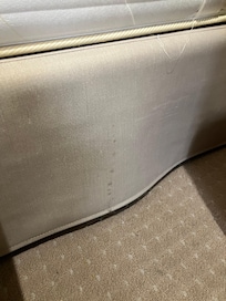 Stain on the side of the bed.