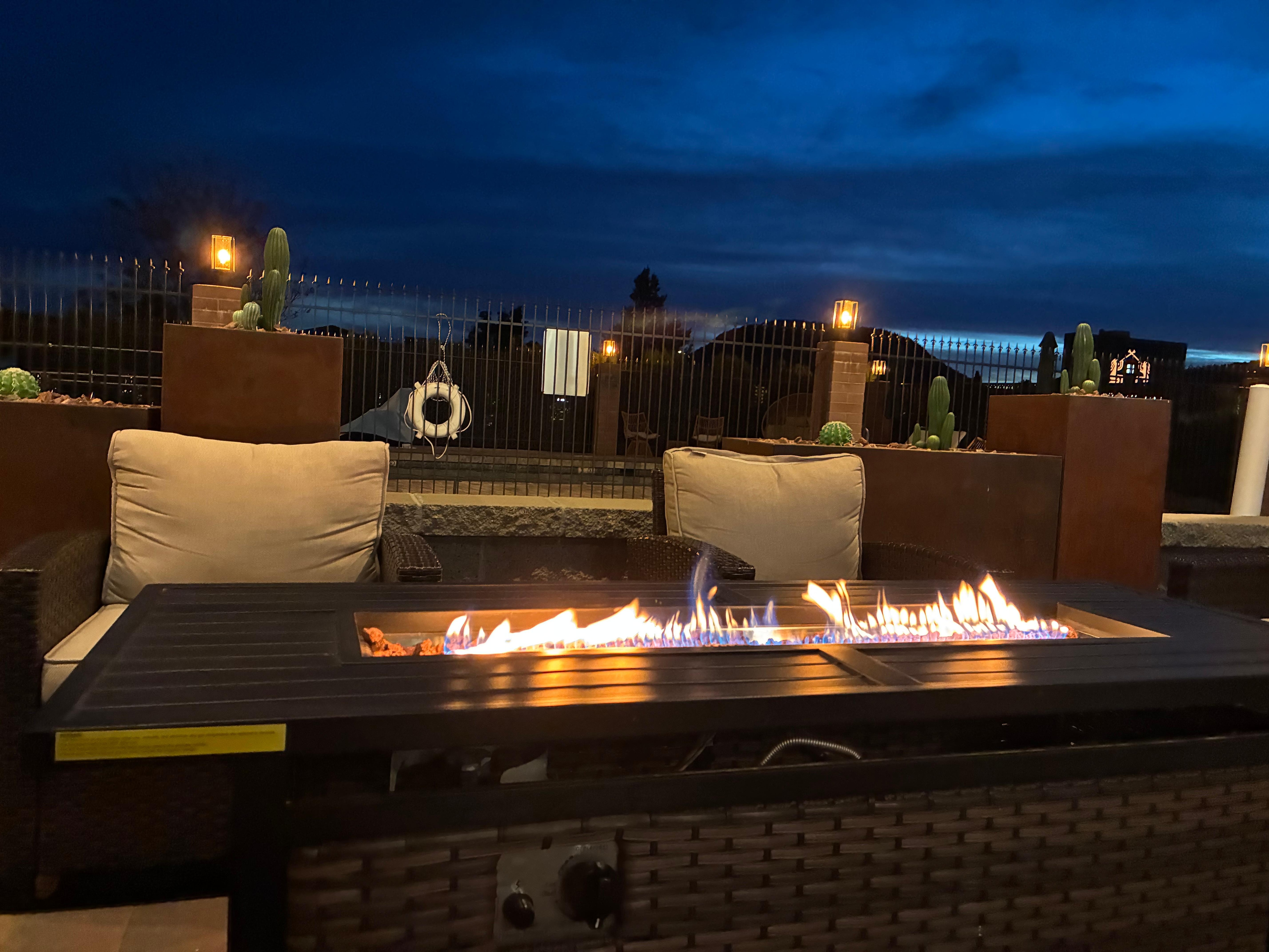 Outdoor seating and firepit table by pool (very nice)