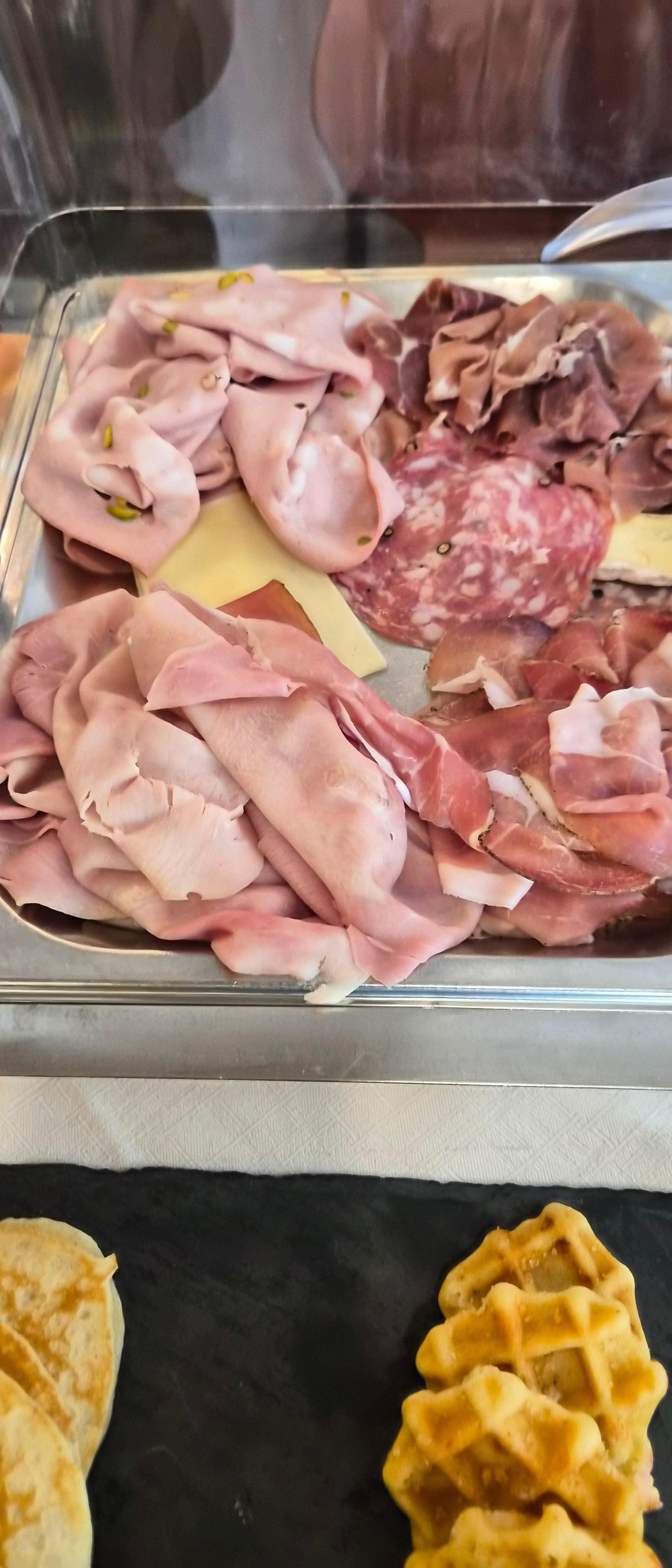 Cheeses "burried" amongst ham and salami.