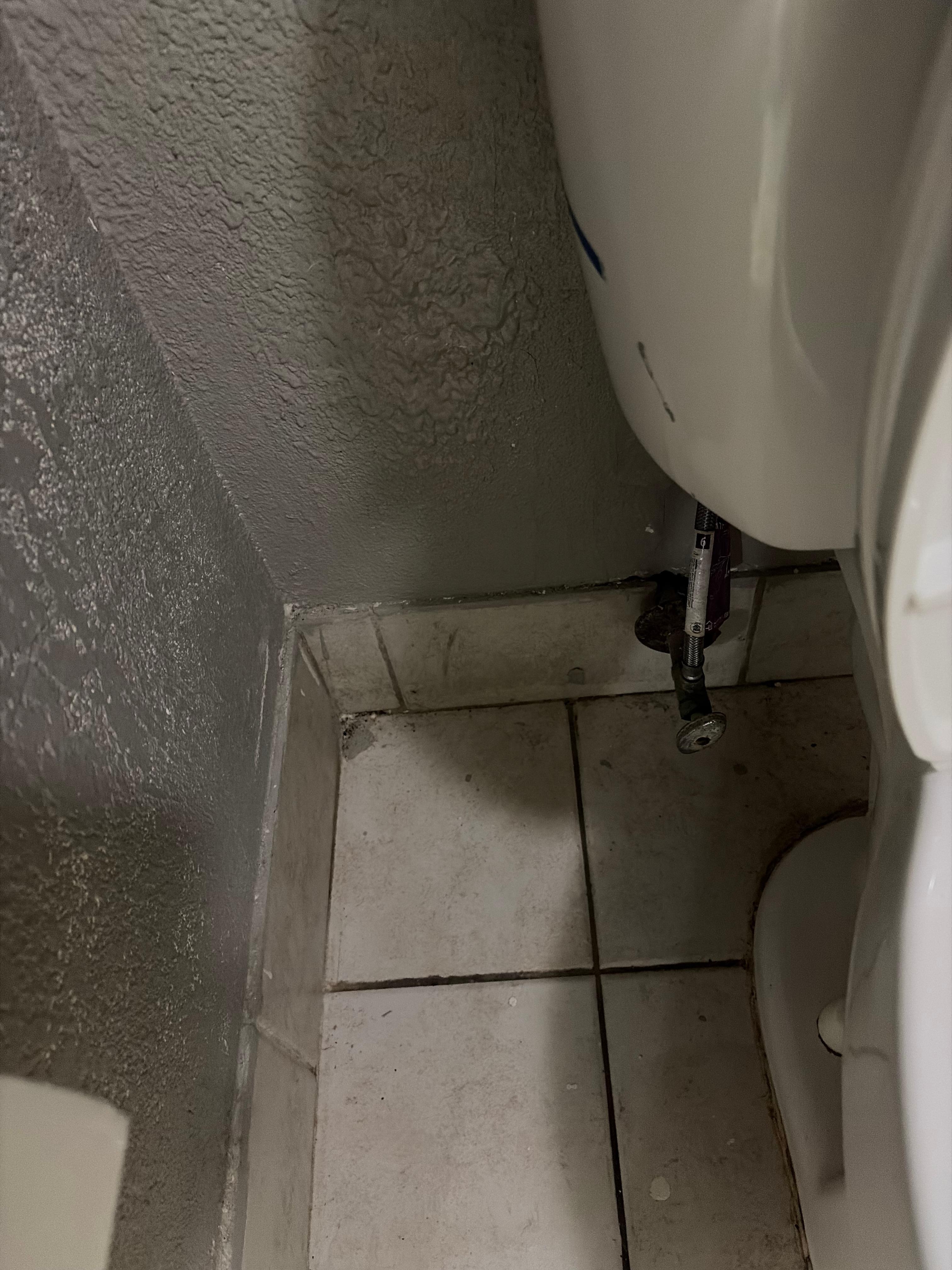 Floor behind toilet