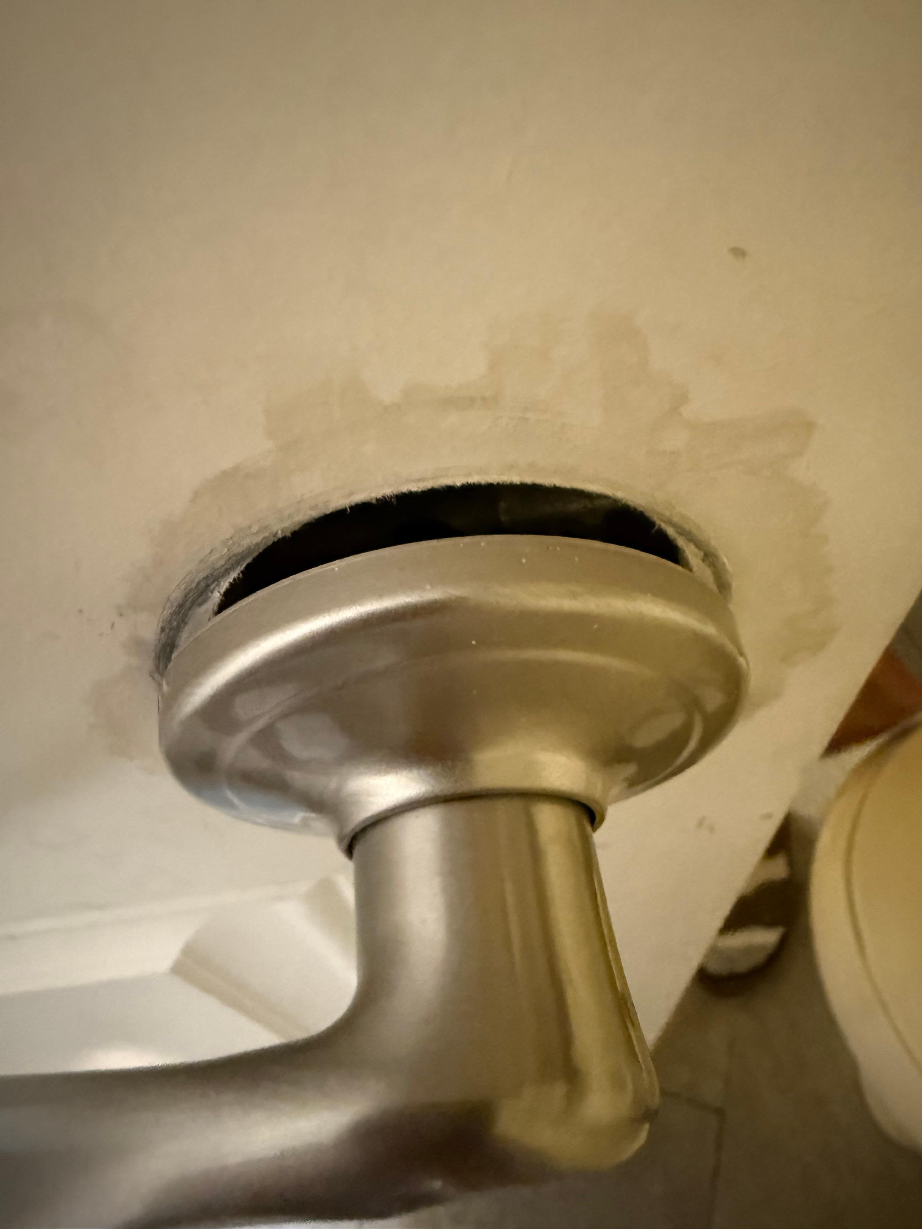 Broken door handle on a delaminated door