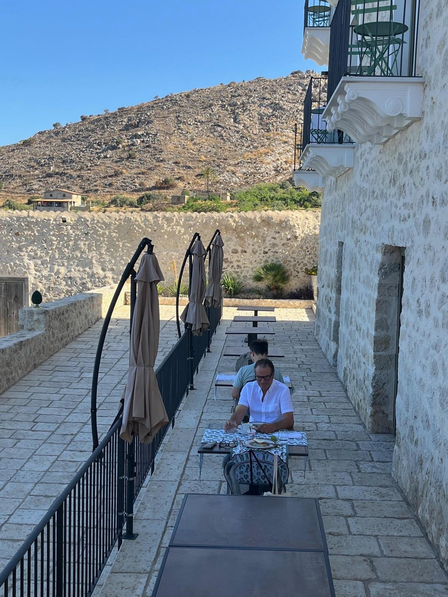 Front of hotel in the morning with breakfast tables laid