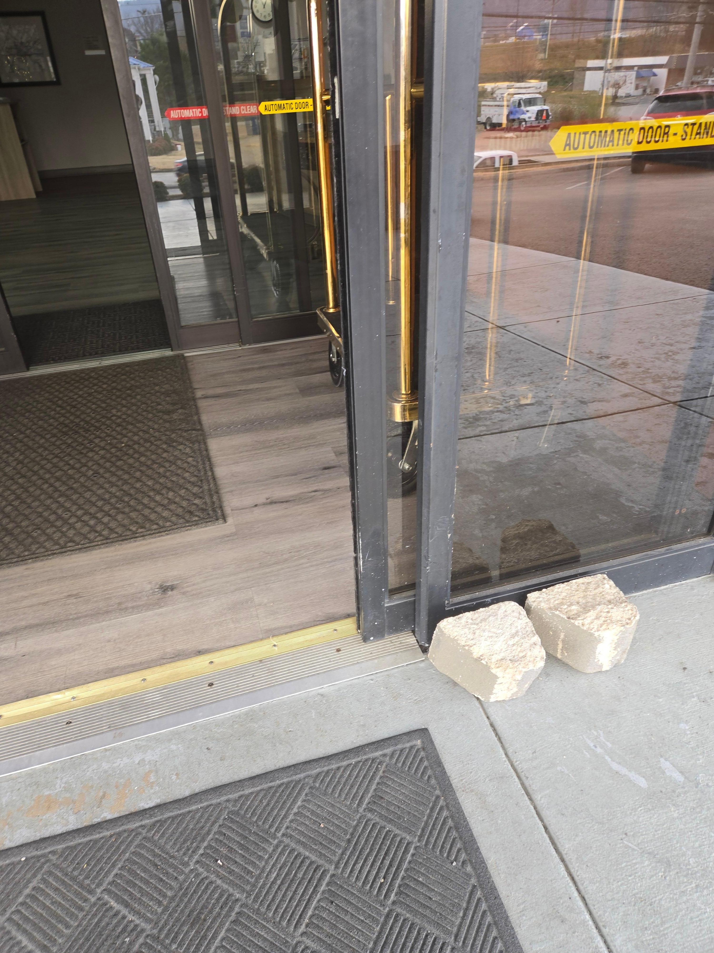 Outer door being held opened by big boulders