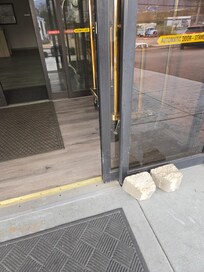 Outer door being held opened by big boulders