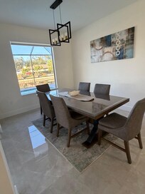 Spacious dining area with view of pool and canal