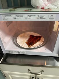 Old partially eaten slice of Pepperoni Pizza we found in the Microwave oven.