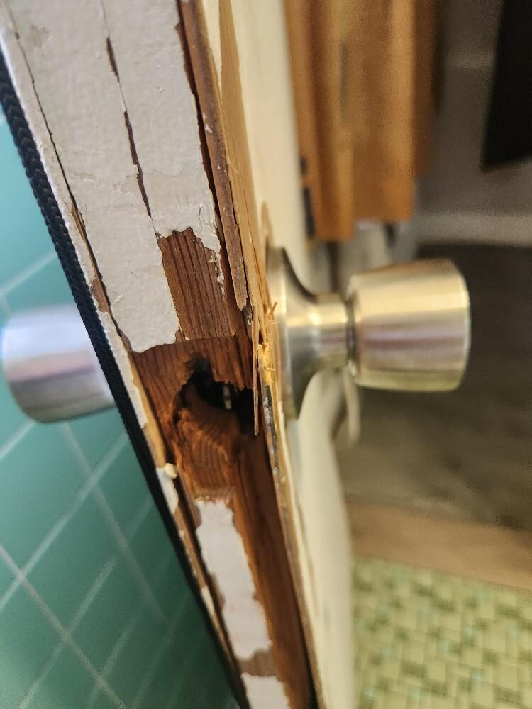 Bathroom door #2 - a close up showing the missing piece necessary to keep door closed in the door frame
