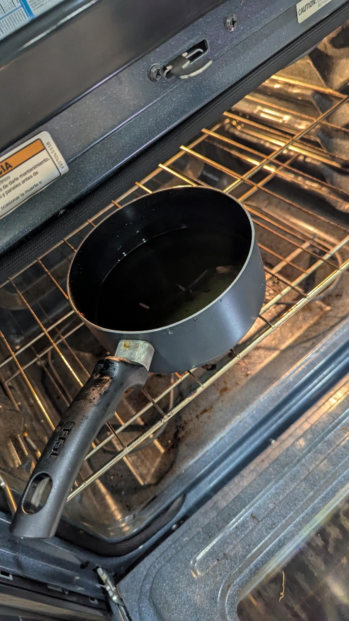 Pot of oil left in the oven.