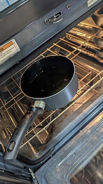 Pot of oil left in the oven.