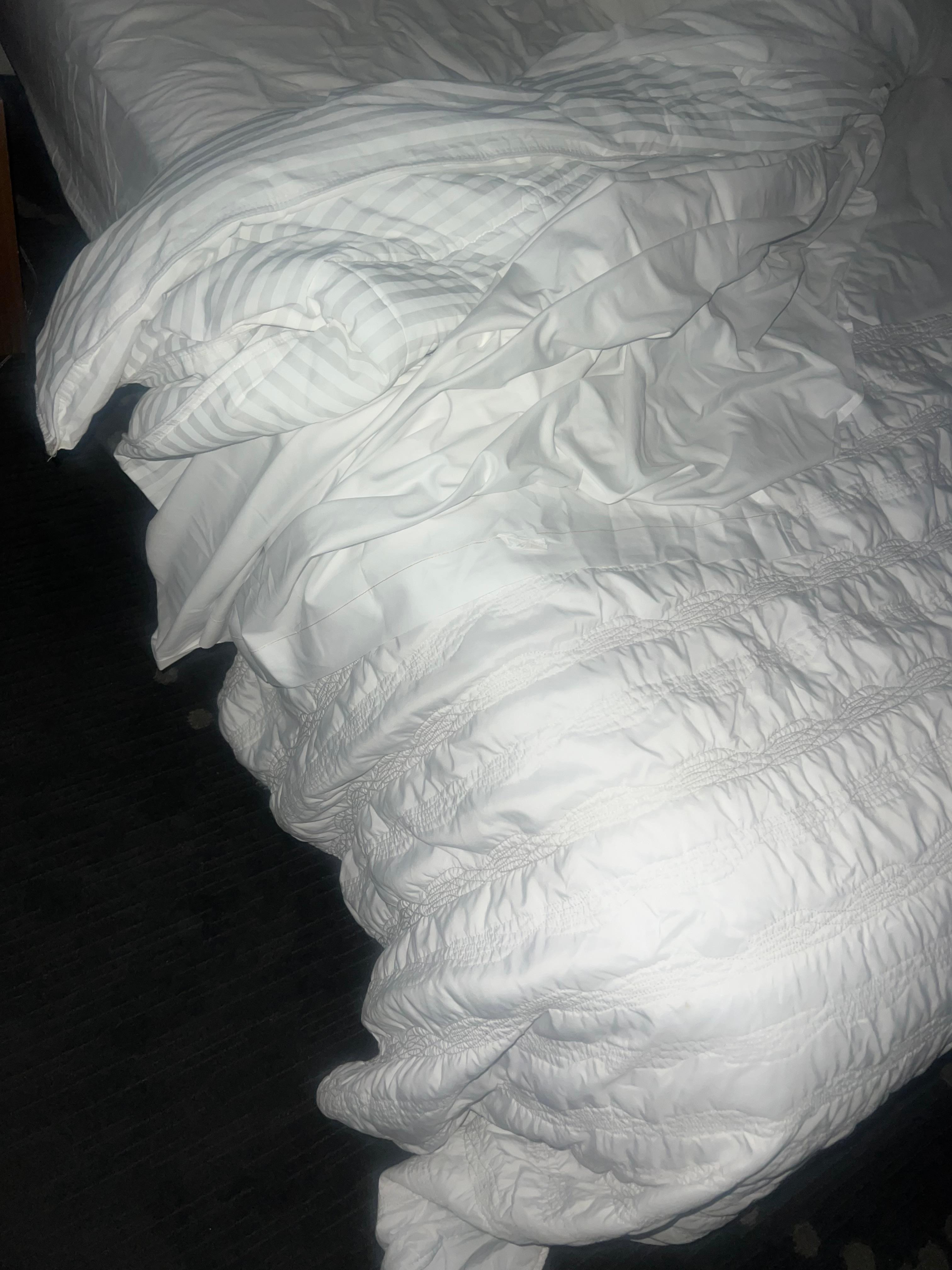 Beds were so low all the beddings mingle with the dirty carpets 