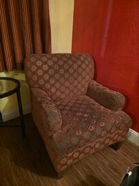 Filthy, thread bare, and stained arm chair.