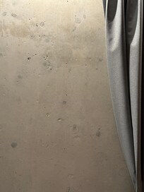 One wall of the room which was covered by a drape.