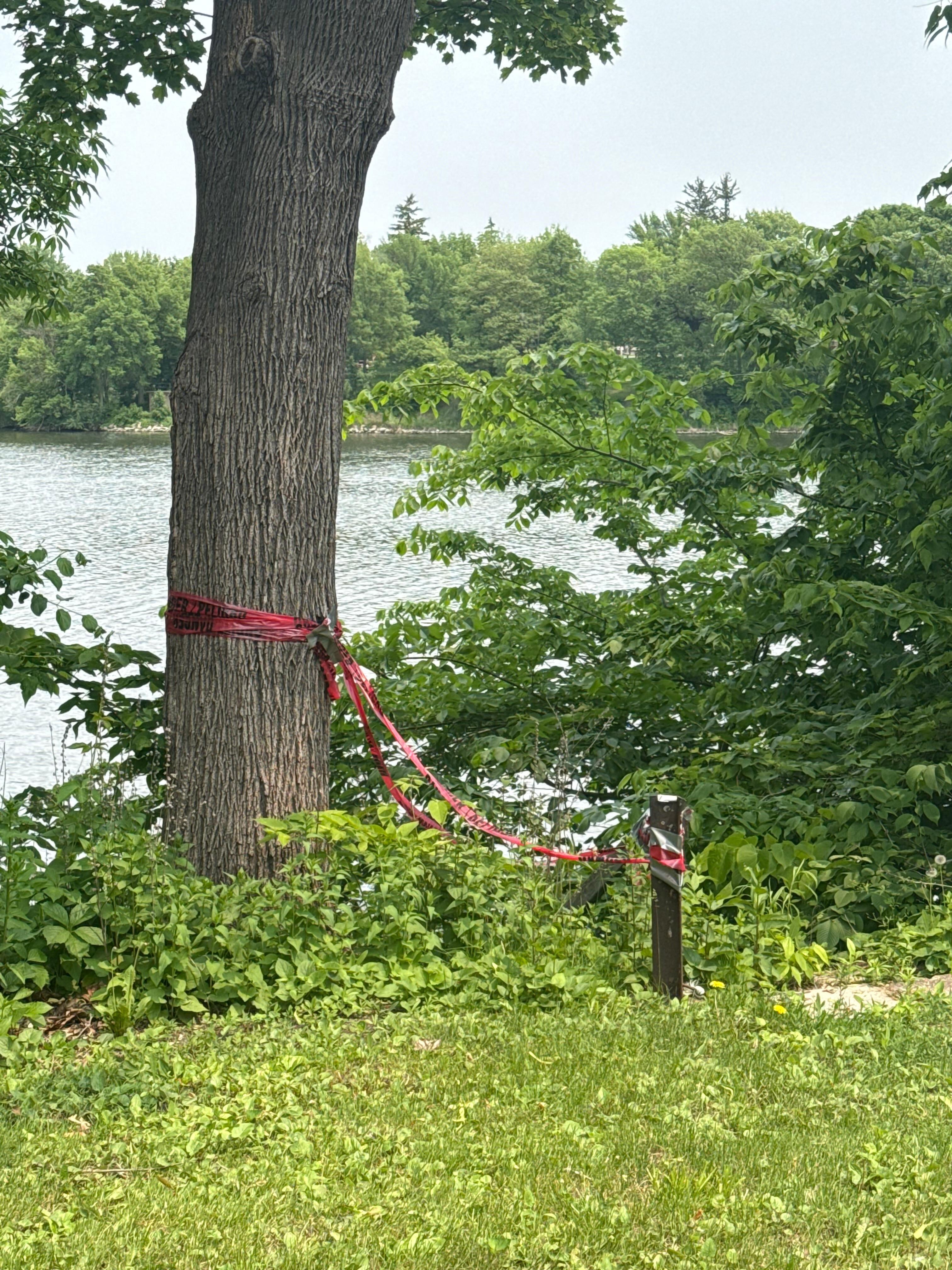 Red tape blocked the stairs to the lake, barring entry.