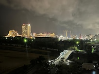 View of the city at night off the balcony on the edge of the ocean!